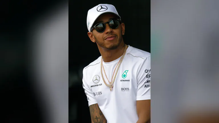 Lewis Hamilton i vit teamtröja och keps under Malaysias Grand Prix 2017.